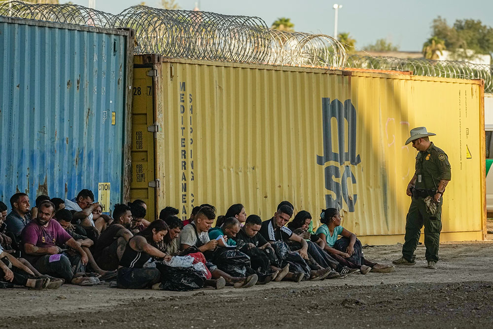 Migrants who crossed the Rio Grande and entered the U.S. from Mexico are lined up for processing by U.S. Customs and Border Protection Sept. 23, 2023, in Eagle Pass, Texas. (AP/Eric Gay)